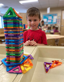 A child playing with a colorful plastic blocks

AI-generated content may be incorrect.