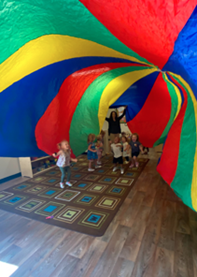A group of children standing under a large colorful tent

AI-generated content may be incorrect.